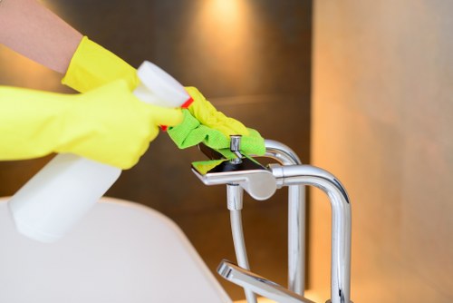 Carpet cleaning technician preparing equipment safely in Alperton