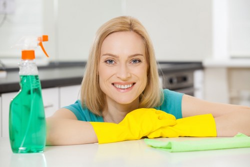 Carpet cleaning staff following health and safety procedures with equipment and caution signs